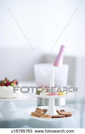 Stock Image - Cakestand with cookies, cake and an ice bucket with champagne. Fotosearch