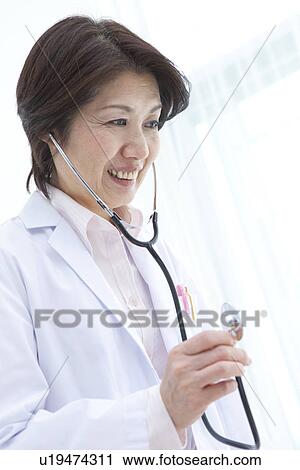 Stock Image - Cheerful doctor with stethoscope. Fotosearch