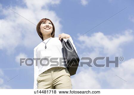 Cheerful young woman with handbag View Large Photo Image Stock Photo - Cheerful young woman with handbag. Fotosearch