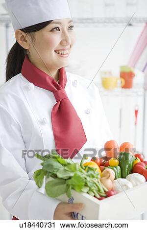 Chef holding a box of vegetables View Large Photo Image Stock Image - Chef holding a box of vegetables. Fotosearch