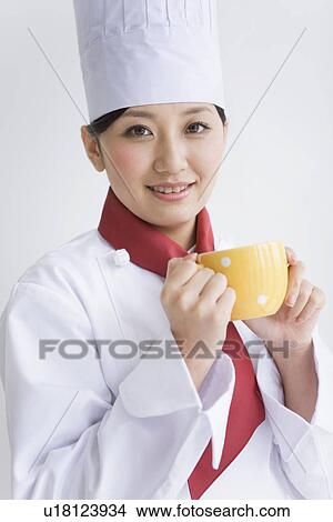 Picture - Chef holding coffee cup. Fotosearch
