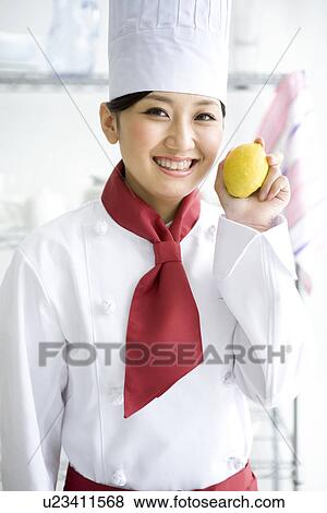 Chef holding up a lemon View Large Photo Image Stock Photo - Chef holding up a lemon. Fotosearch
