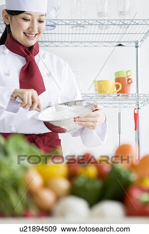 Chef whisking ingredients in a bowl behind a box of vegetables View Large Photo Image Stock Photo - Chef whisking ingredients in a bowl behind a box of vegetables. Fotosearch