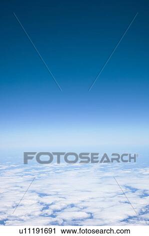 Stock Image - Clouds in blue sky. Fotosearch