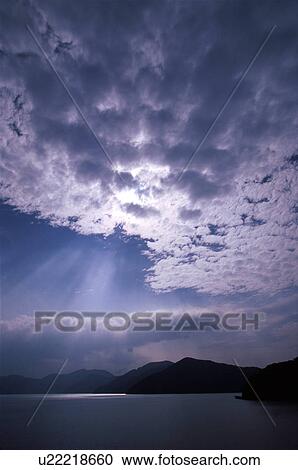Stock Image - Cloudscape over lake. Fotosearch
