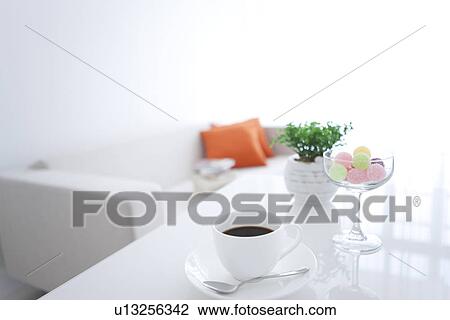 Coffee and a glass of candy on a living room table View Large Photo Image Stock Image - Coffee and a glass of candy on a living room table. Fotosearch
