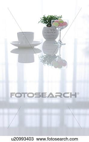 Coffee and a glass of candy on a living room table View Large Photo Image Stock Image - Coffee and a glass of candy on a living room table. Fotosearch