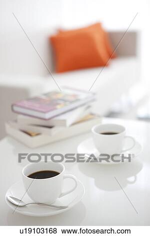 Coffee and books on a living room table View Large Photo Image Stock Photo - Coffee and books on a living room table. Fotosearch