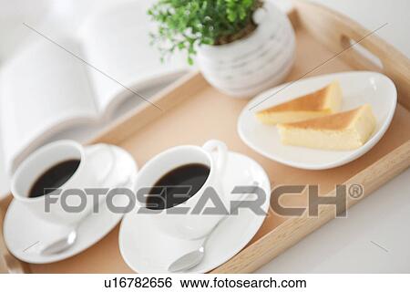 Stock Photograph - Coffee and cake on a serving tray. Fotosearch