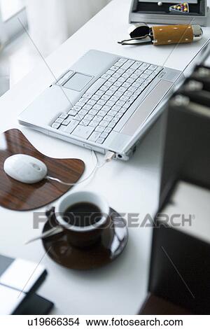 Coffee and laptop on desk View Large Photo Image Picture - Coffee and laptop on desk. Fotosearch