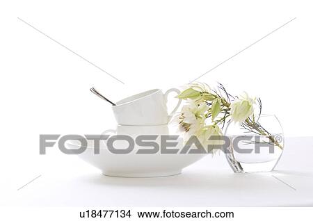 Coffee cups stacked on table with vase of flowers View Large Photo Image Picture - Coffee cups stacked on table with vase of flowers. Fotosearch