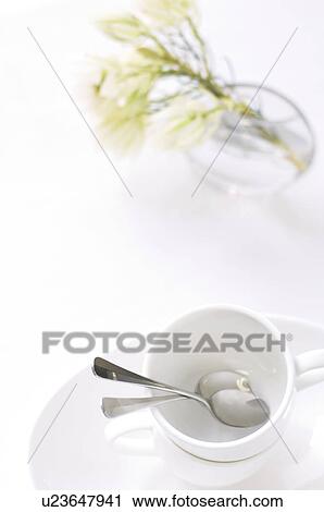 Coffee cups stacked on table with vase of flowers View Large Photo Image Stock Image - Coffee cups stacked on table with vase of flowers. Fotosearch