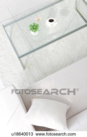 Stock Image - Coffee table and a white sofa. Fotosearch