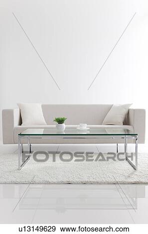 Stock Photo - Coffee table and a white sofa. Fotosearch