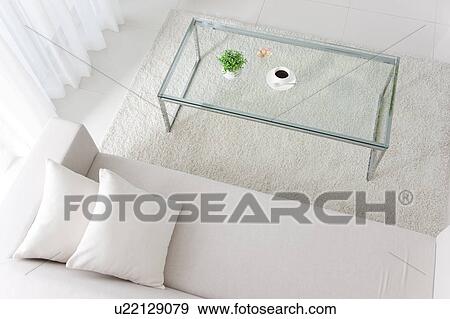 Coffee table and a white sofa View Large Photo Image Stock Photo - Coffee table and a white sofa. Fotosearch