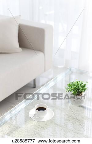 Stock Photo - Coffee table and a white sofa. Fotosearch