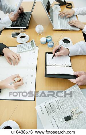 Colleagues working at desk in office View Large Photo Image Stock Image - Colleagues working at desk in office. Fotosearch