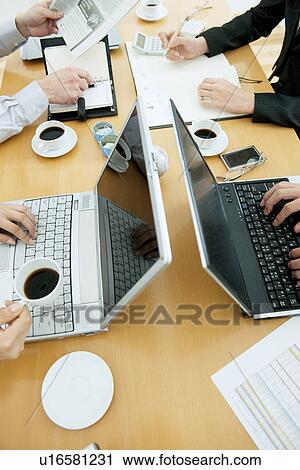 Colleagues working at desk in office View Large Photo Image Stock Image - Colleagues working at desk in office. Fotosearch