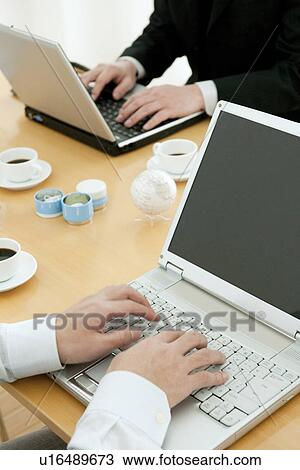Stock Image - Colleagues working in office. Fotosearch