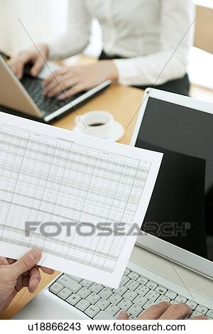 Stock Image - Colleagues working in office. Fotosearch