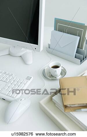 Computer on desk with coffee cup and address book View Large Photo Image Stock Photograph - Computer on desk with coffee cup and address book. Fotosearch