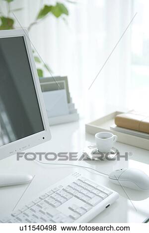 Stock Photo - Computer on desk with coffee cup. Fotosearch
