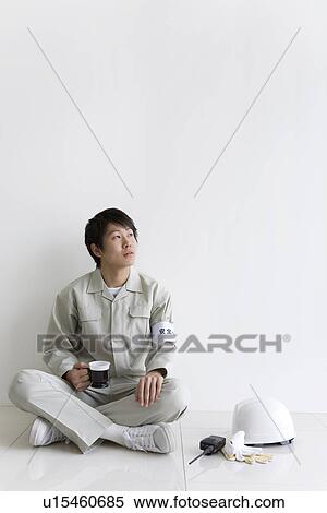 Stock Photography - Construction worker resting with a hot drink. Fotosearch