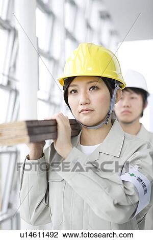 Construction workers carrying wooden planks View Large Photo Image Stock Image - Construction workers carrying wooden planks. Fotosearch