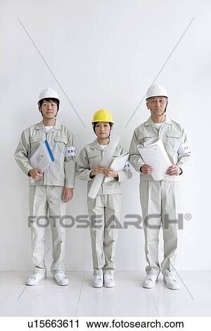 Construction workers holding blueprints and documents View Large Photo Image Stock Image - Construction workers holding blueprints and documents. Fotosearch