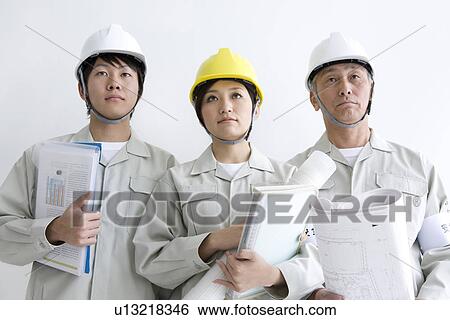 Construction workers holding blueprints and documents View Large Photo Image Stock Photograph - Construction workers holding blueprints and documents. Fotosearch