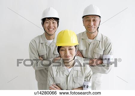 Construction workers smiling at the camera View Large Photo Image Stock Photograph - Construction workers smiling at the camera. Fotosearch