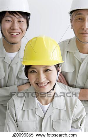 Construction workers smiling at the camera View Large Photo Image Stock Photography - Construction workers smiling at the camera. Fotosearch