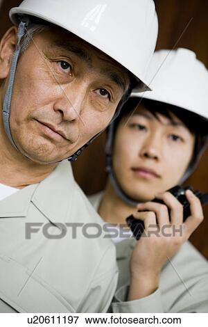 Construction workers with walkie-talkie View Large Photo Image Stock Photo - Construction workers with walkie-talkie. Fotosearch
