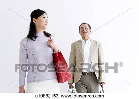 Stock Image - Couple doing some shopping. Fotosearch