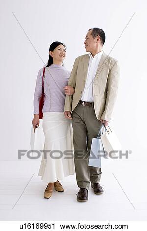 Stock Image - Couple doing some shopping. Fotosearch