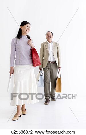 Stock Image - Couple doing some shopping. Fotosearch