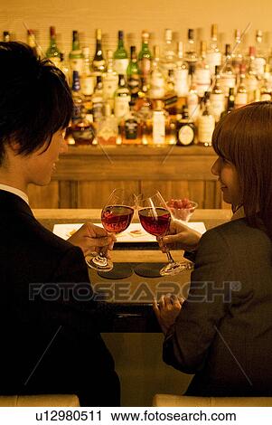 Couple drinking wine at a bar View Large Photo Image Stock Image - Couple drinking wine at a bar. Fotosearch