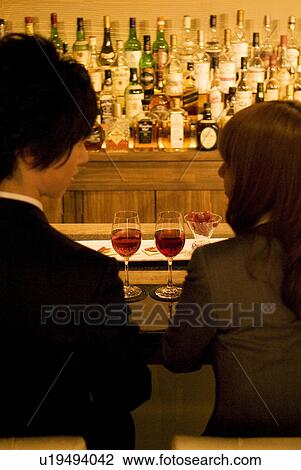 Couple drinking wine at a bar View Large Photo Image Stock Image - Couple drinking wine at a bar. Fotosearch