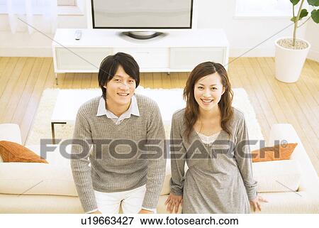 Couple relaxing at home View Large Photo Image Stock Photo - Couple relaxing at home. Fotosearch