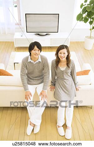 Stock Photo - Couple relaxing at home. Fotosearch