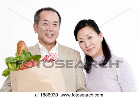 Stock Image - Couple shopping for groceries. Fotosearch