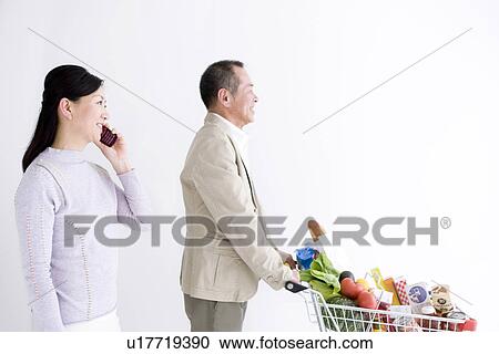 Stock Image - Couple shopping for groceries. Fotosearch