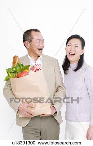 Couple shopping for groceries View Large Photo Image Stock Image - Couple shopping for groceries. Fotosearch