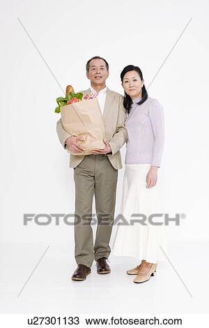 Stock Image - Couple shopping for groceries. Fotosearch