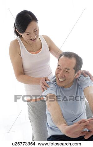 Couple stretching together View Large Photo Image Picture - Couple stretching together. Fotosearch
