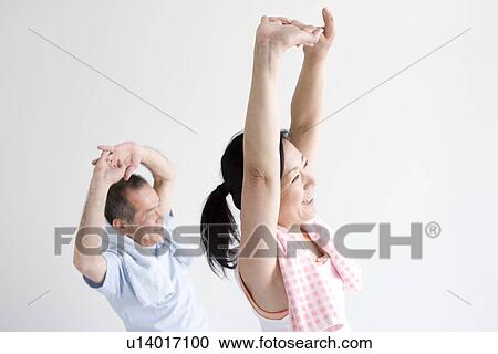Stock Image - Couple stretching together. Fotosearch