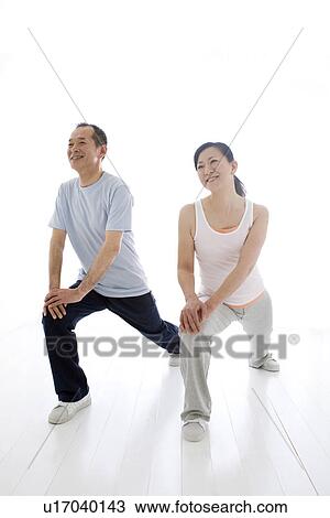 Couple stretching together View Large Photo Image Stock Image - Couple stretching together. Fotosearch