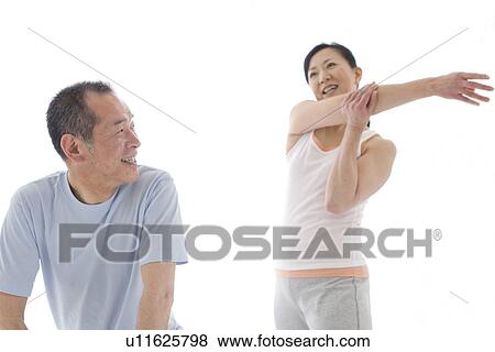 Couple stretching together View Large Photo Image Stock Photo - Couple stretching together. Fotosearch