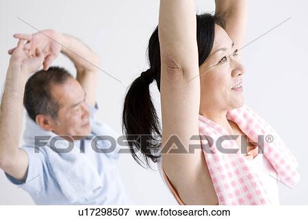 Couple stretching together View Large Photo Image Stock Photo - Couple stretching together. Fotosearch