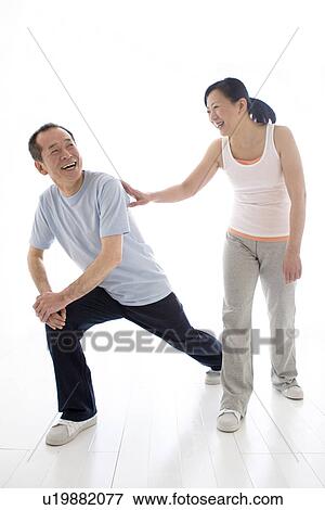 Couple stretching together View Large Photo Image Stock Photo - Couple stretching together. Fotosearch